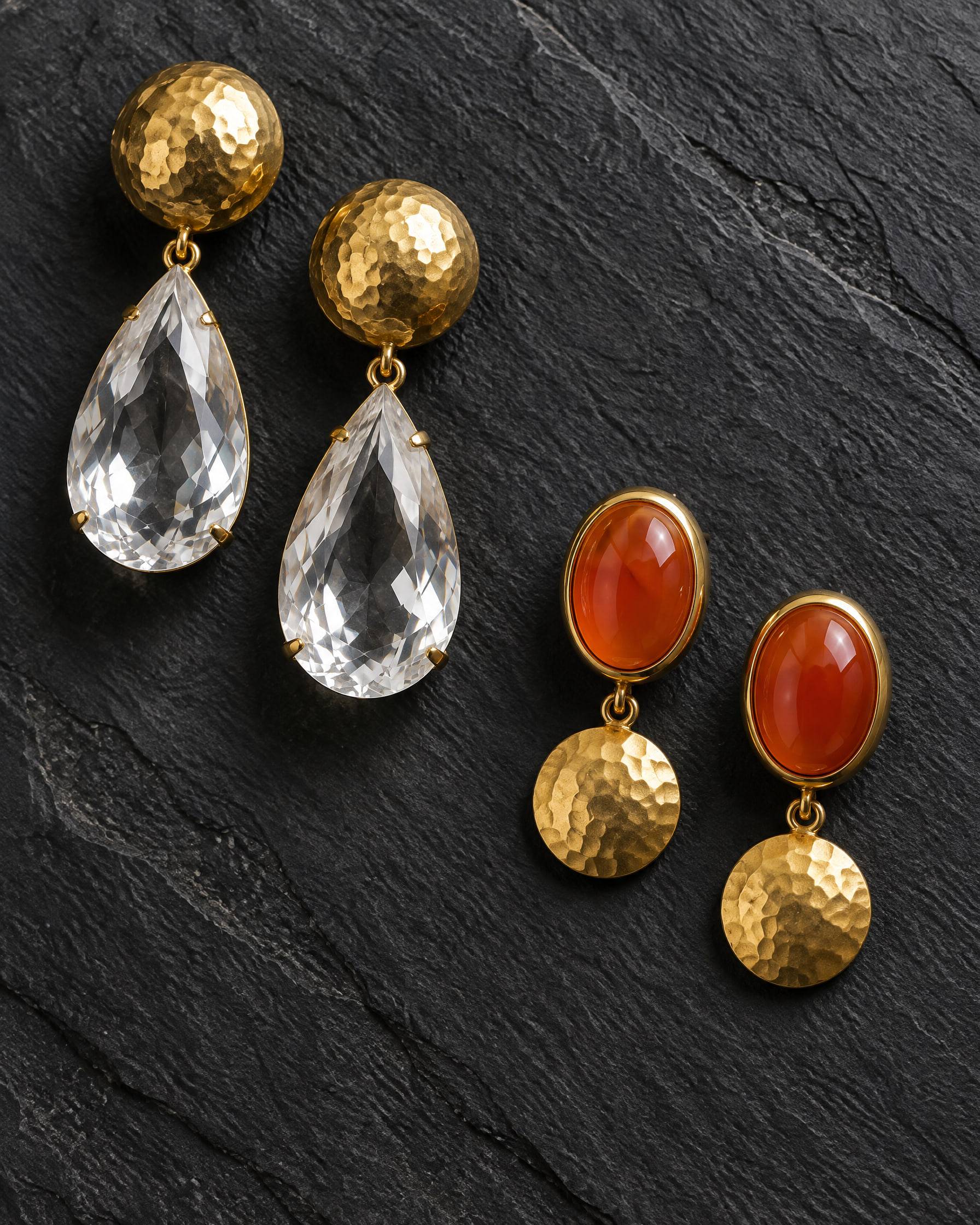 Statement earrings on slate: hammered gold domes with faceted rock crystal drops, and carnelian cabochons in gold bezels.